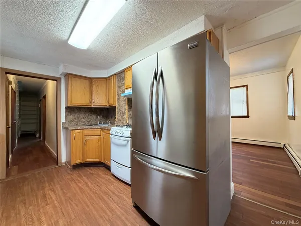 a metallic refrigerator freezer sitting in a kitchen