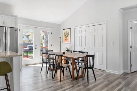 a view of a a dining room with furniture window and wooden floor