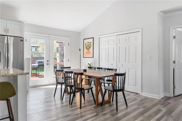 a view of a a dining room with furniture window and wooden floor