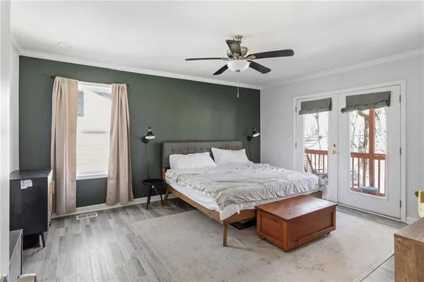 a bedroom with a bed and a chandelier