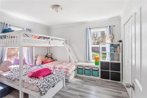a bedroom with furniture and a window