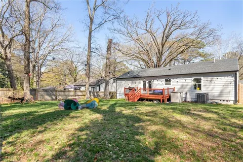 a view of a backyard with a table and chairs