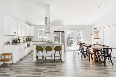 a large kitchen with a table and chairs