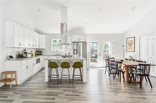 a large kitchen with a table and chairs