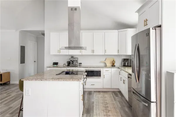 a kitchen with stainless steel appliances granite countertop a refrigerator sink and stove
