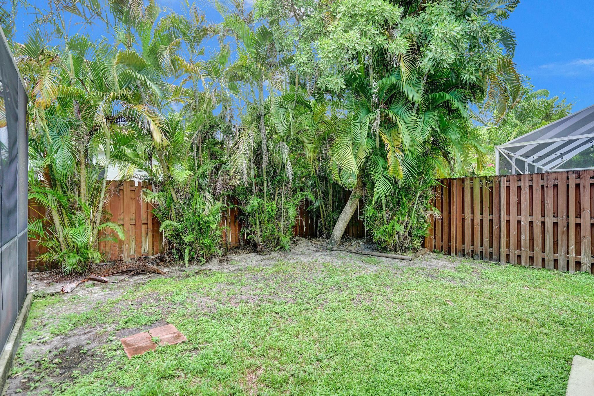 11290 Renaissance Road Cooper City, FL 33026 - Photo 54 of 55 a backyard of a house with lots of green space
