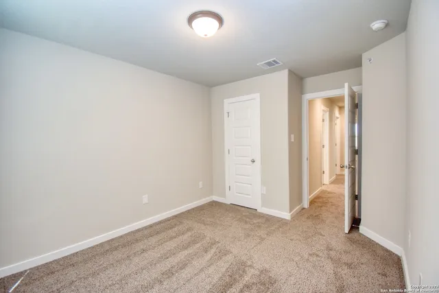 an empty room with closet area