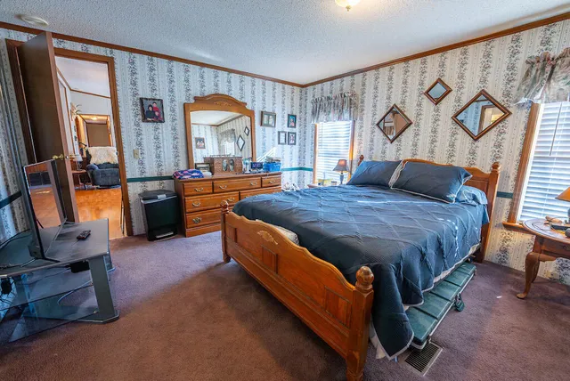 a bedroom with a bed and a mirror