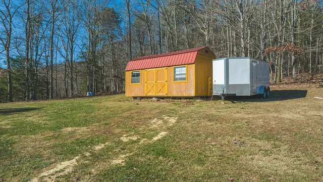 a backyard of a house with yard and trampoline