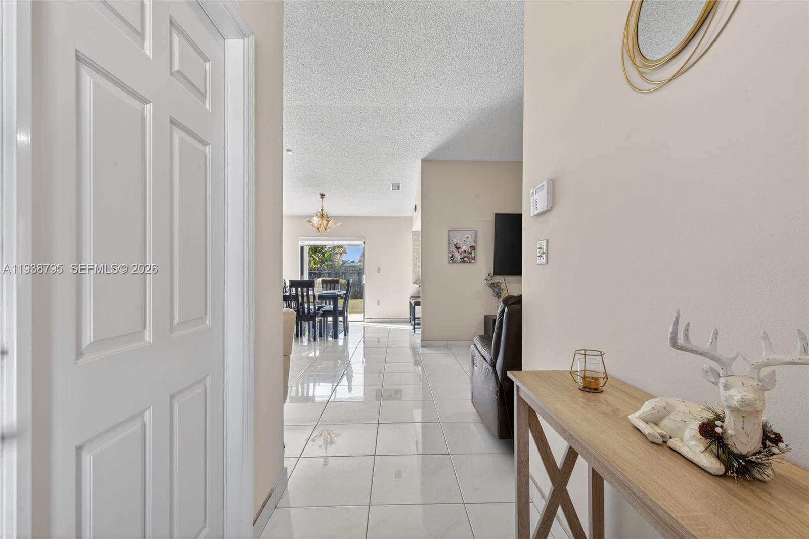 1136 Southwest 139th Place Miami, FL 33184 - Photo 11 of 42 a dining room with furniture and a chandelier