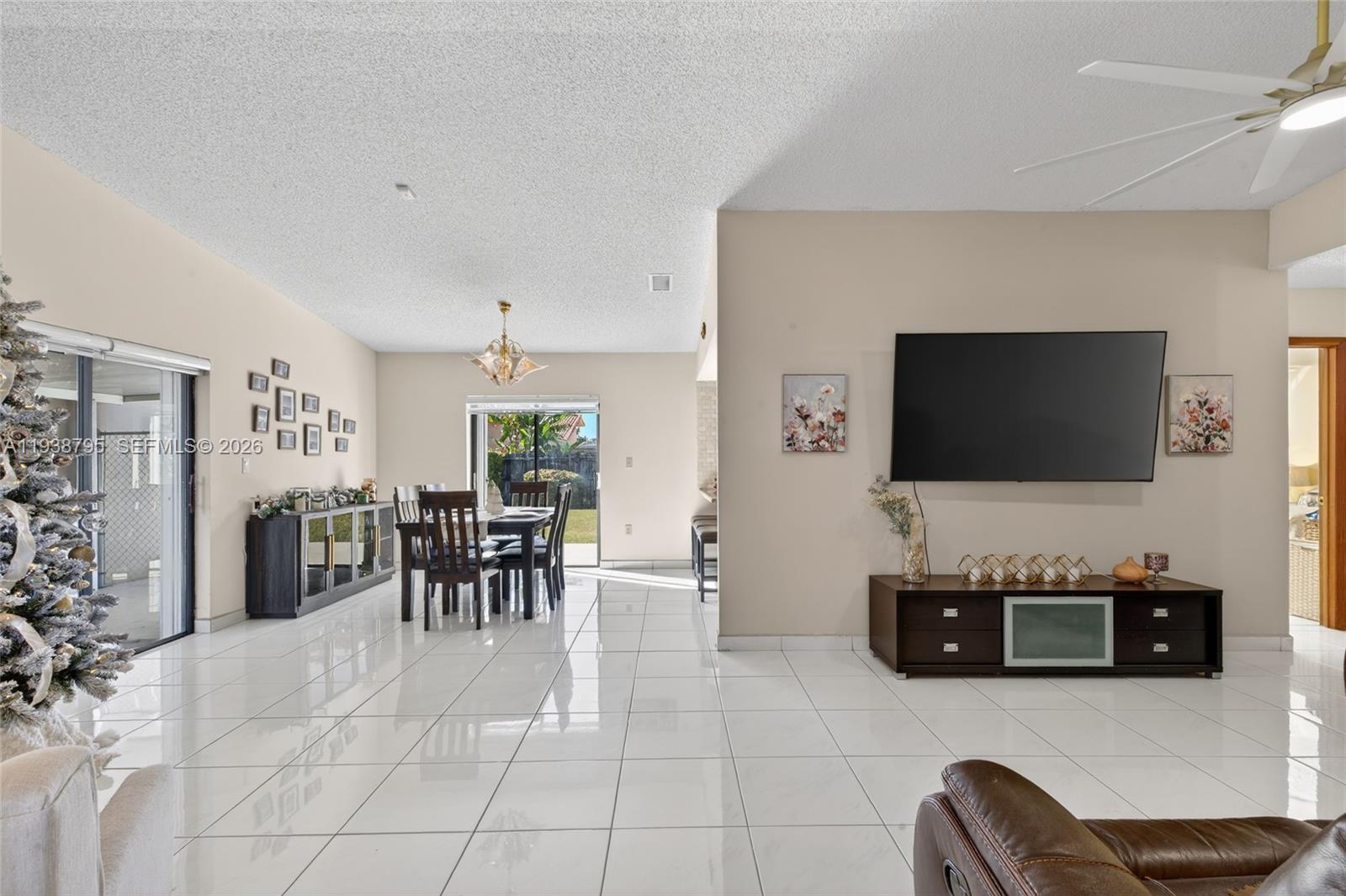 1136 Southwest 139th Place Miami, FL 33184 - Photo 13 of 42 a living room with furniture and a flat screen tv
