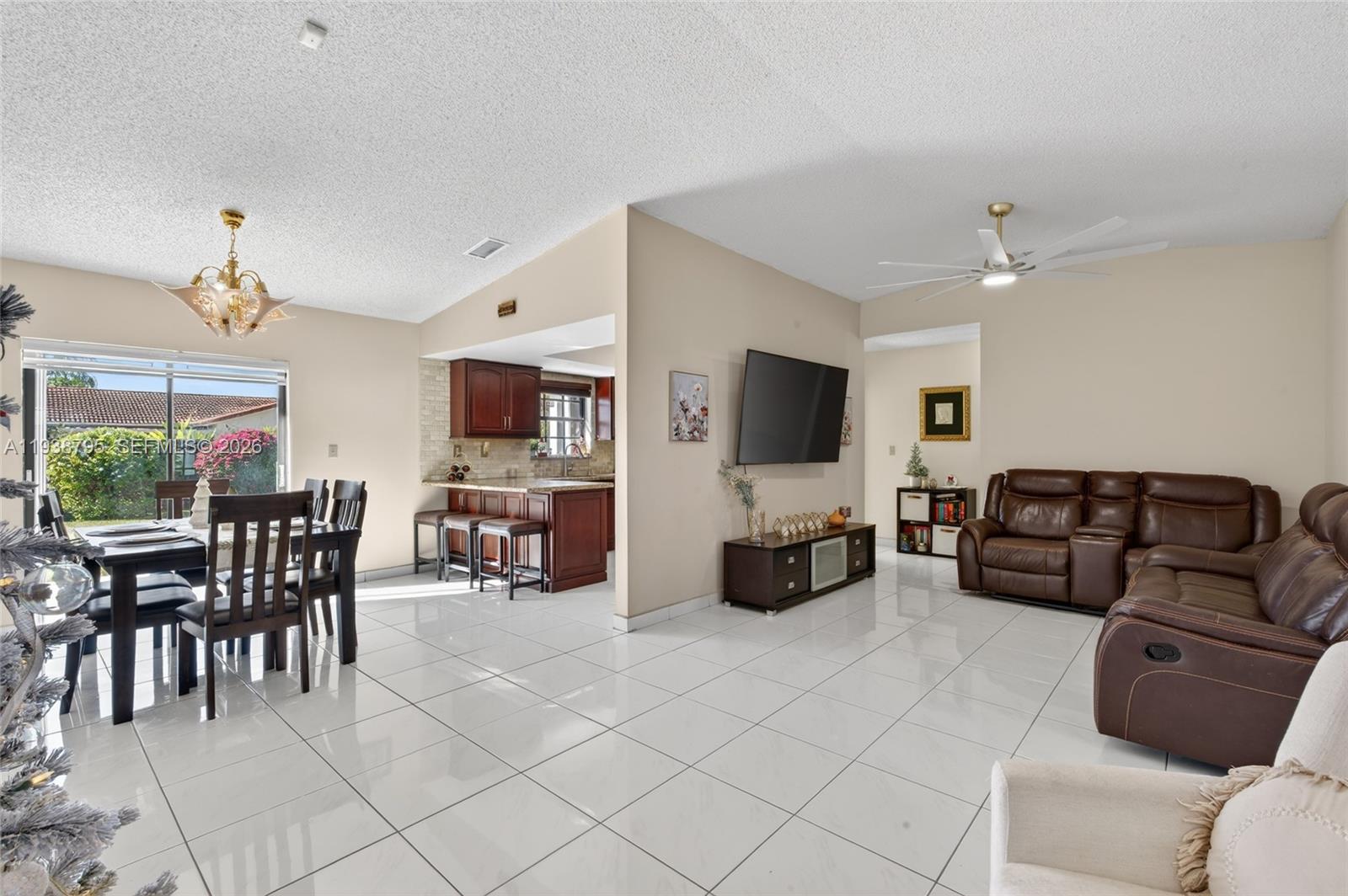 1136 Southwest 139th Place Miami, FL 33184 - Photo 14 of 42 a living room with furniture and a flat screen tv