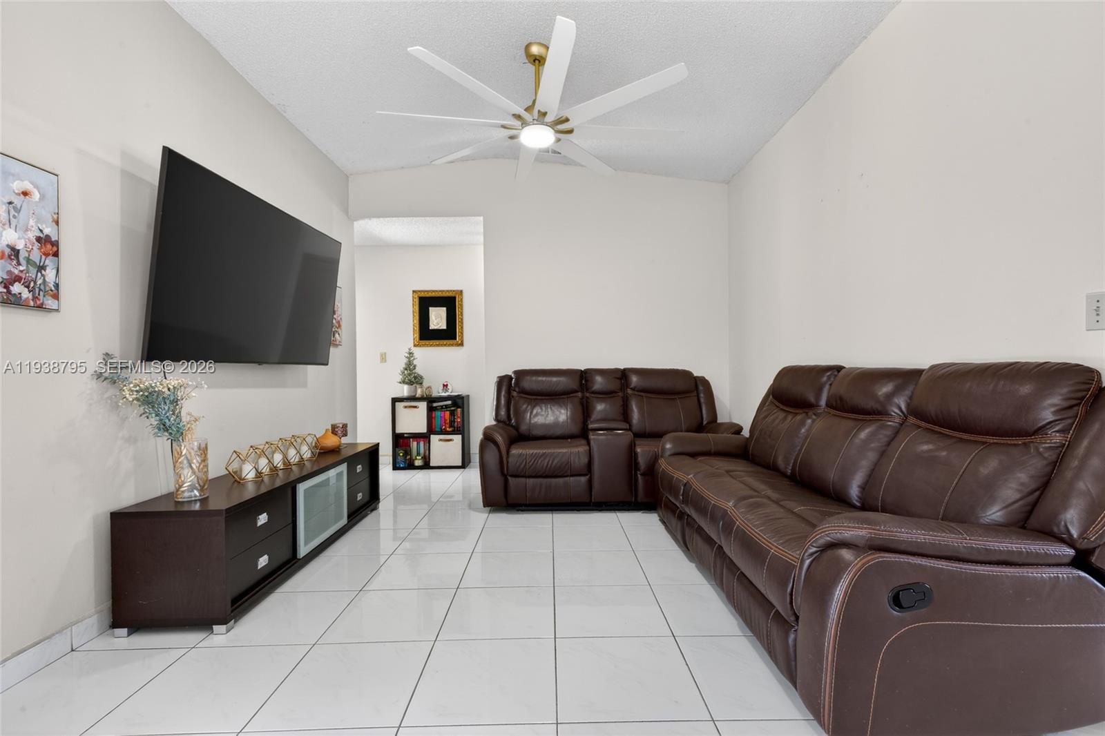 1136 Southwest 139th Place Miami, FL 33184 - Photo 16 of 42 a living room with furniture and a flat screen tv