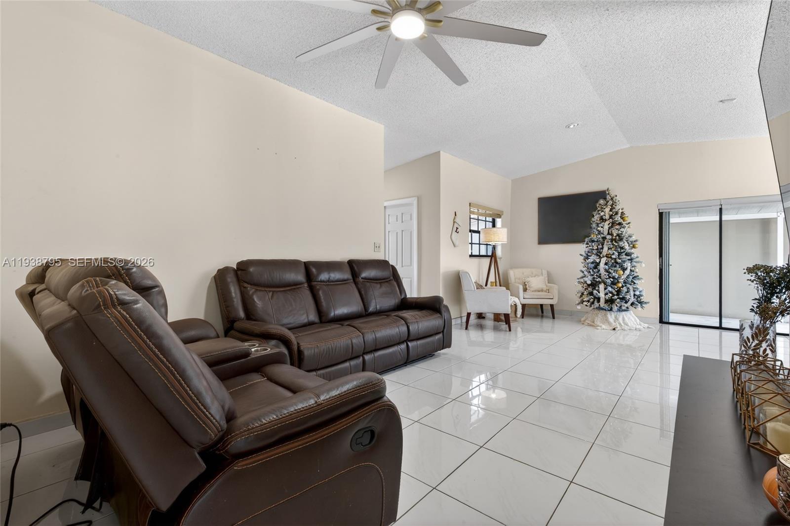 1136 Southwest 139th Place Miami, FL 33184 - Photo 18 of 42 a living room with furniture and a chandelier