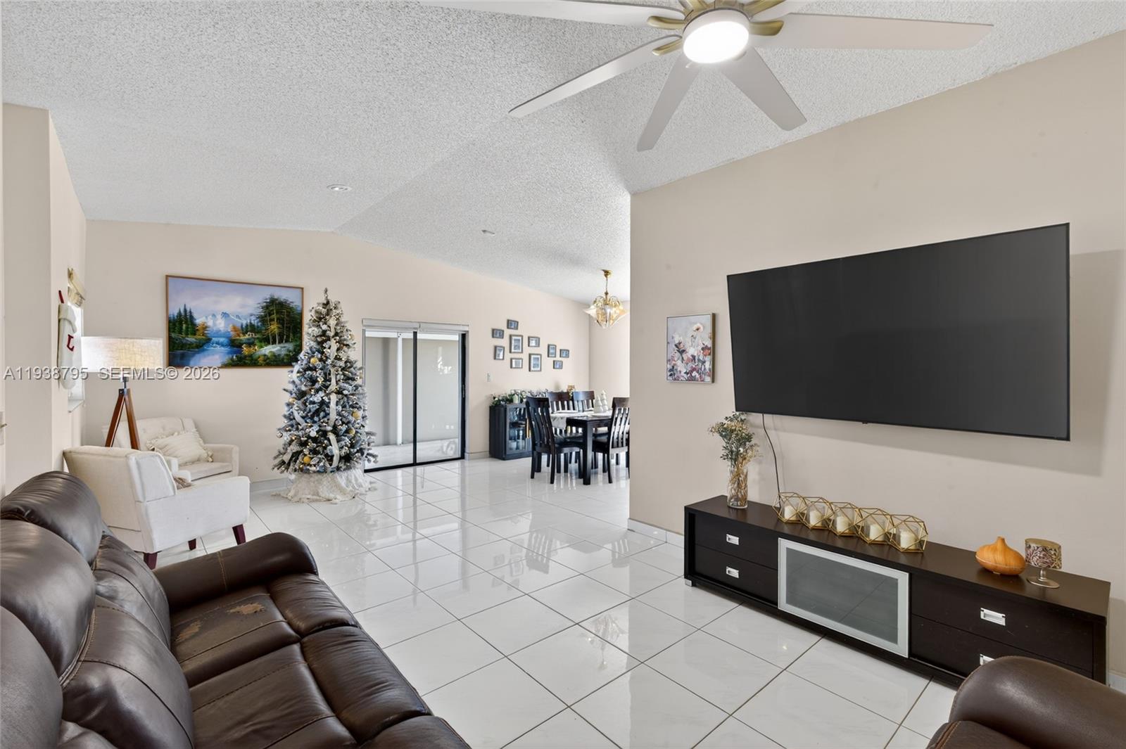 1136 Southwest 139th Place Miami, FL 33184 - Photo 19 of 42 a living room with furniture and a flat screen tv