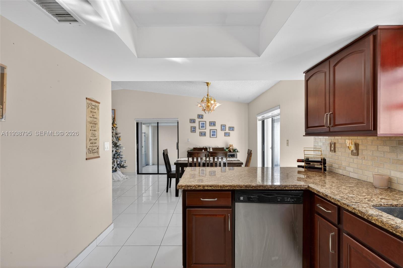 1136 Southwest 139th Place Miami, FL 33184 - Photo 25 of 42 a kitchen with a sink refrigerator and cabinets