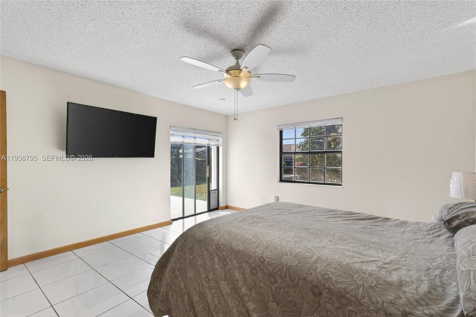 1136 Southwest 139th Place Miami, FL 33184 - Photo 29 of 42 a bedroom with a bed and a flat screen tv