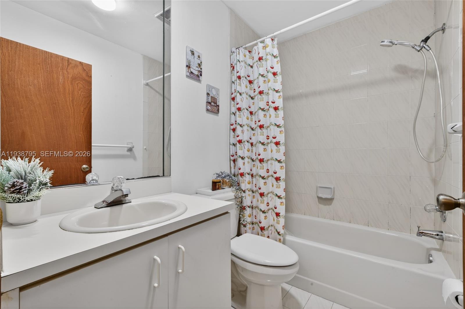 1136 Southwest 139th Place Miami, FL 33184 - Photo 33 of 42 a bathroom with a sink toilet a shower and a mirror