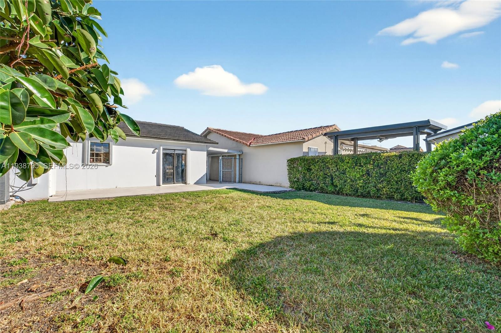 1136 Southwest 139th Place Miami, FL 33184 - Photo 41 of 42 a view of a house with a backyard and a tree