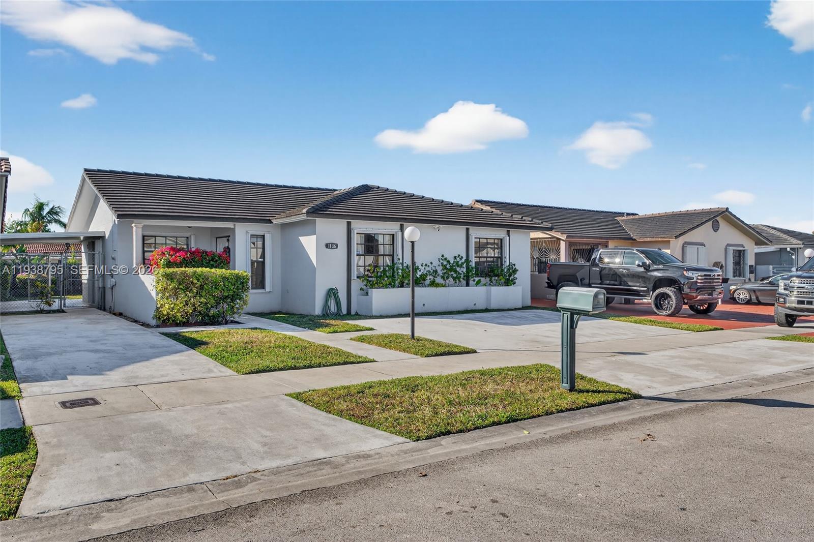 1136 Southwest 139th Place Miami, FL 33184 - Photo 7 of 42 a front view of a house with a yard and potted plants