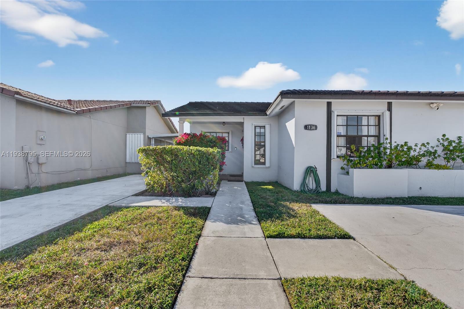 1136 Southwest 139th Place Miami, FL 33184 - Photo 8 of 42 front view of a house with a yard
