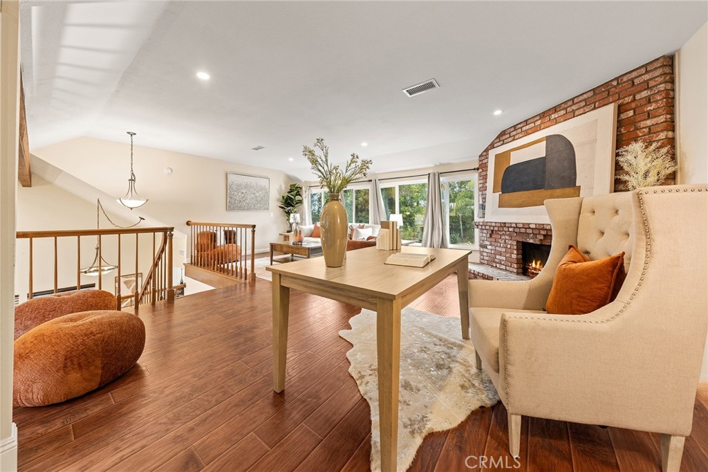 6296 Marble Avenue Rancho Cucamonga, CA 91701 - Photo 43 of 89 a living room with furniture a dining table and a fireplace