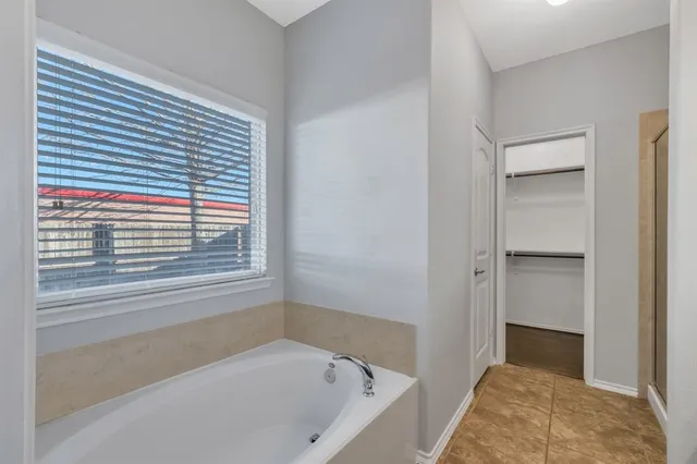 a bathroom with a bathtub and a shower