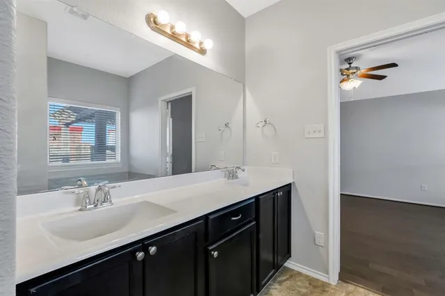 a bathroom with a sink a vanity and a mirror