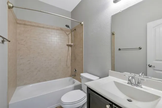 a bathroom with a sink a toilet and a bathtub