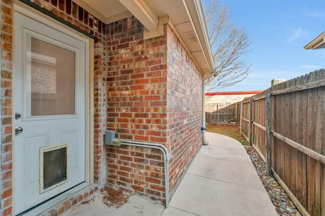 a view of a balcony with wooden floor and iron stairs