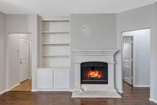 a living room with a fireplace and a fireplace
