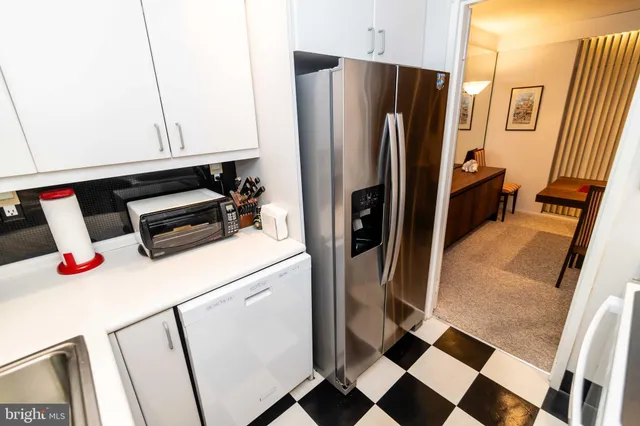 a view of a dining room with furniture and floor to ceiling window