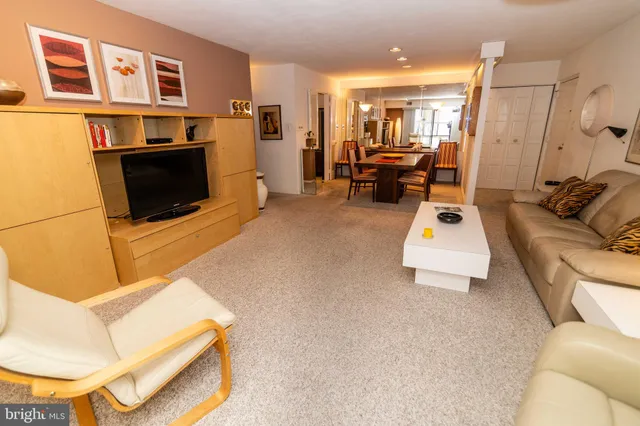 a view of a hallway with furniture and a large window
