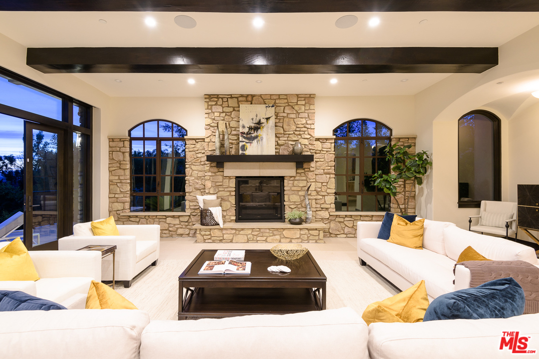 2175 Summitridge Drive Beverly Hills, CA 90210 - Photo 12 of 51 a living room with fireplace furniture and a large window