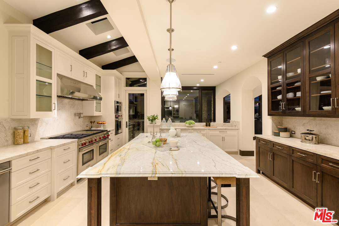 2175 Summitridge Drive Beverly Hills, CA 90210 - Photo 16 of 51 a kitchen with stainless steel appliances kitchen island granite countertop a sink and cabinets