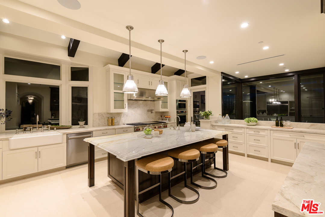 2175 Summitridge Drive Beverly Hills, CA 90210 - Photo 18 of 51 a large kitchen with a table and chairs