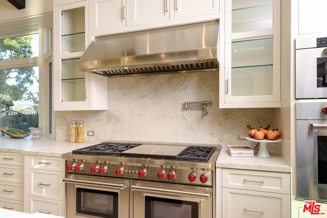 2175 Summitridge Drive Beverly Hills, CA 90210 - Photo 20 of 51 a stove top oven sitting inside of a kitchen