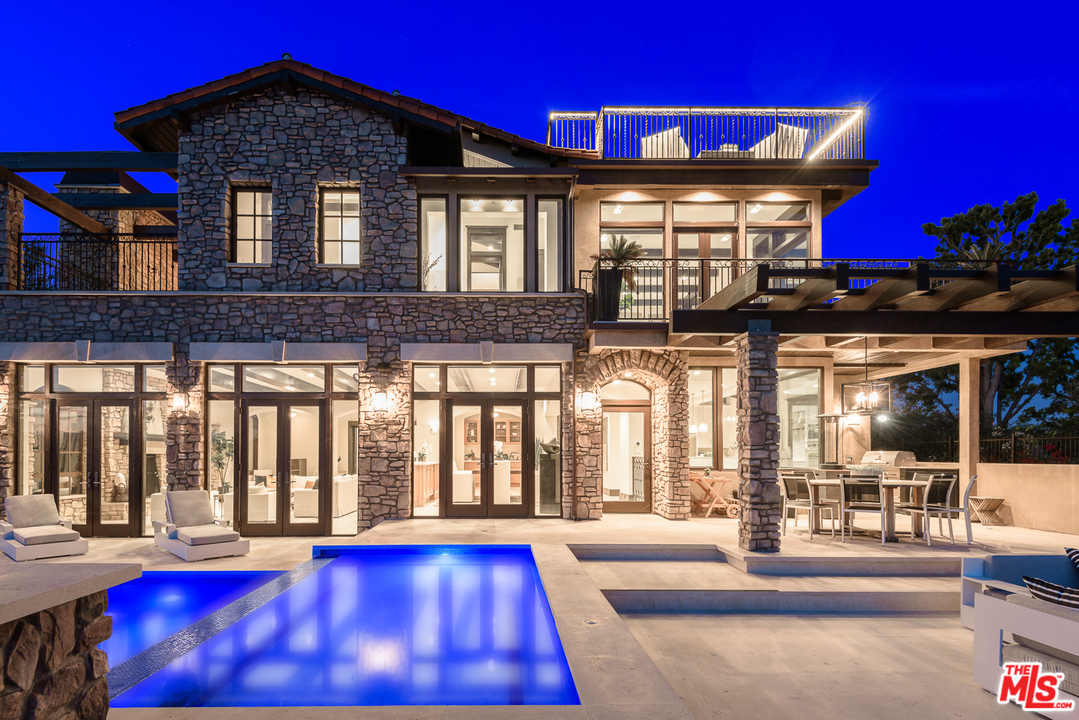 2175 Summitridge Drive Beverly Hills, CA 90210 - Photo 2 of 51 a front view of a house with a porch