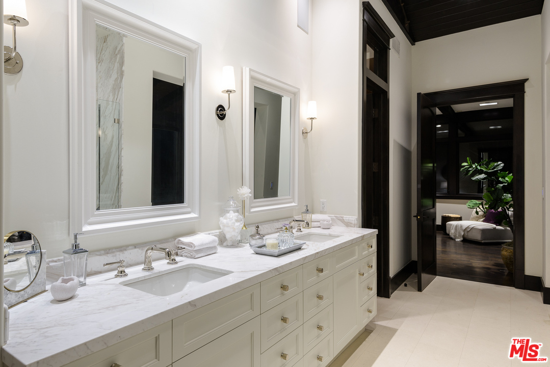 2175 Summitridge Drive Beverly Hills, CA 90210 - Photo 28 of 51 a bathroom with a sink and a mirror