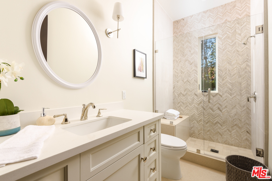 2175 Summitridge Drive Beverly Hills, CA 90210 - Photo 35 of 51 a bathroom with a sink a toilet and a mirror