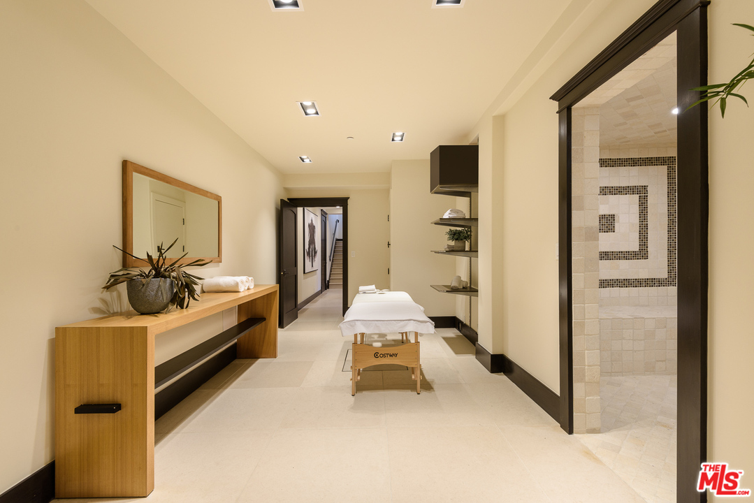 2175 Summitridge Drive Beverly Hills, CA 90210 - Photo 40 of 51 a spacious bedroom with a bed and gym equipment