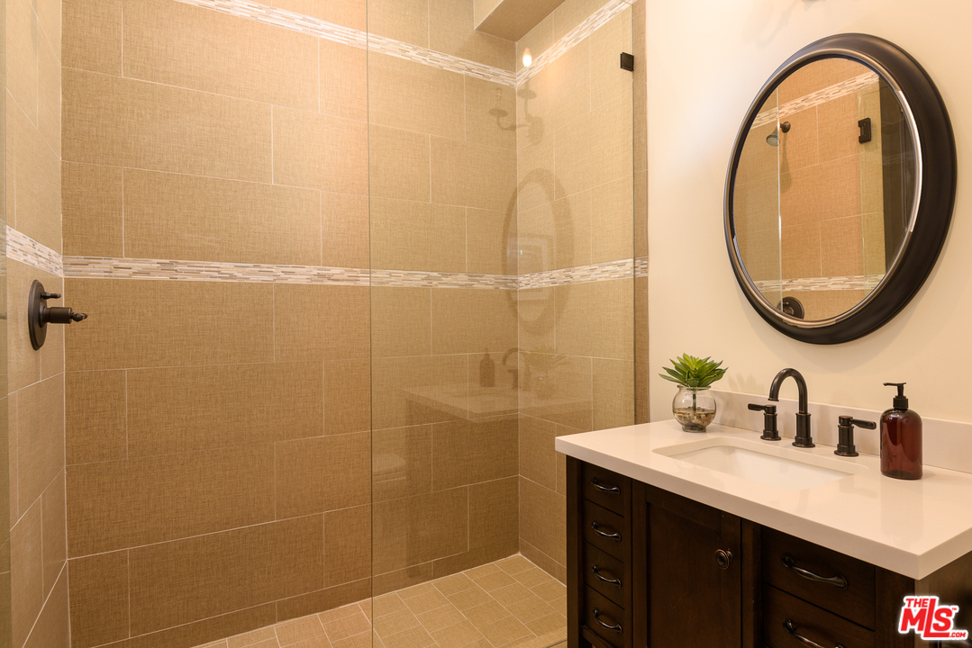 2175 Summitridge Drive Beverly Hills, CA 90210 - Photo 42 of 51 a bathroom with a sink and a mirror