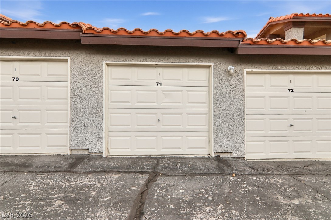 1575 West Warm Springs Road, Unit 2212 Henderson, NV 89014 - Photo 19 of 29 Spanish tile roofing and stucco siding accent these functional garage bays.