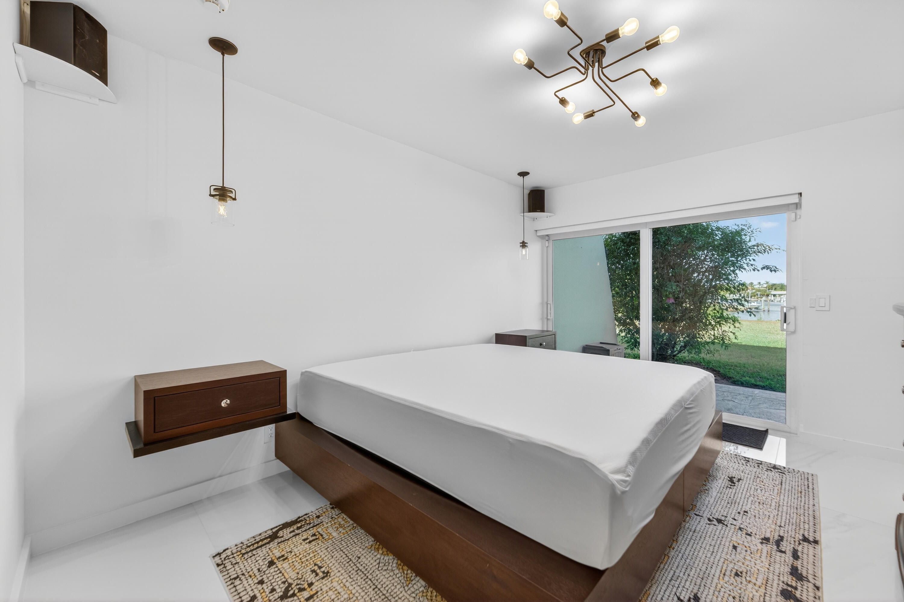 725 Hummingbird Way, Unit 103 North Palm Beach, FL 33408 - Photo 14 of 52 a room with a bed and a window