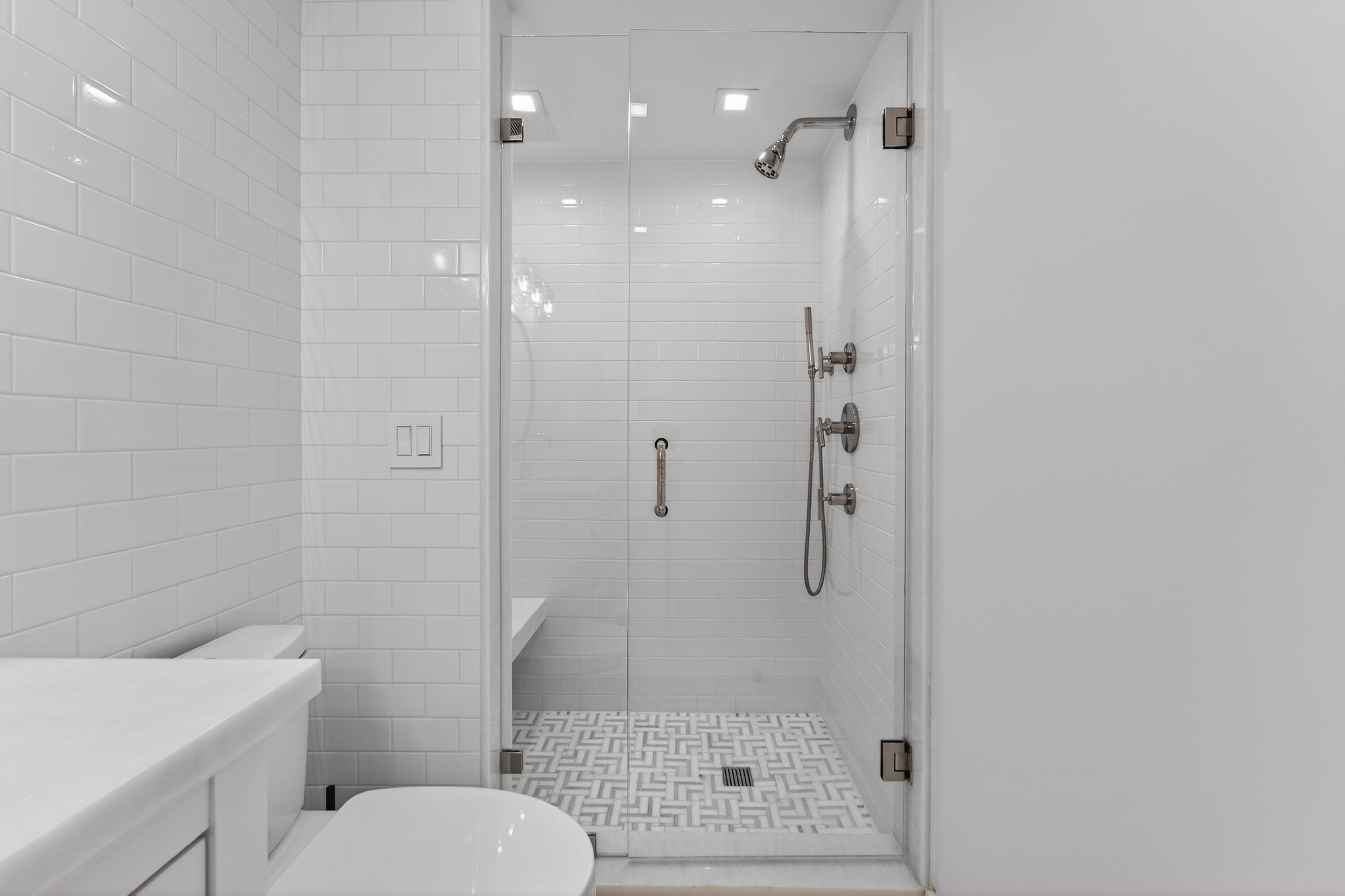 725 Hummingbird Way, Unit 103 North Palm Beach, FL 33408 - Photo 18 of 52 a bathroom with a shower a toilet and a sink