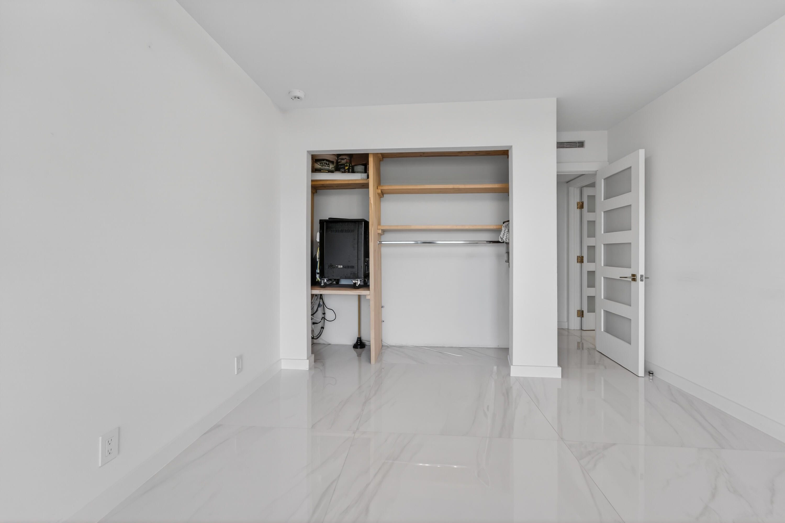 725 Hummingbird Way, Unit 103 North Palm Beach, FL 33408 - Photo 22 of 52 a view of an empty room with a closet