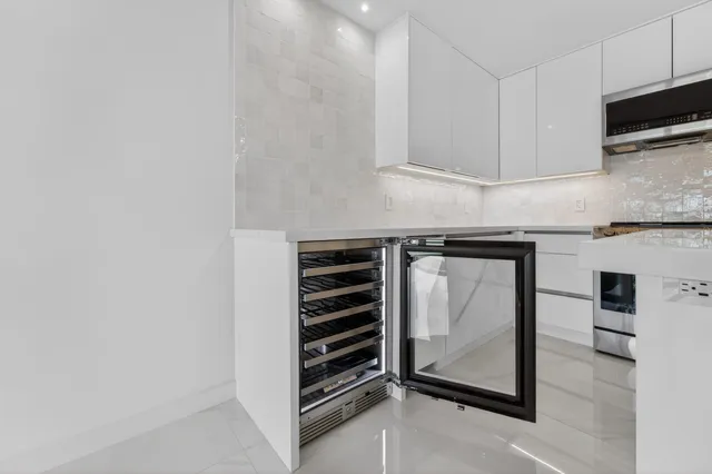 a kitchen with stainless steel appliances a refrigerator sink and cabinets