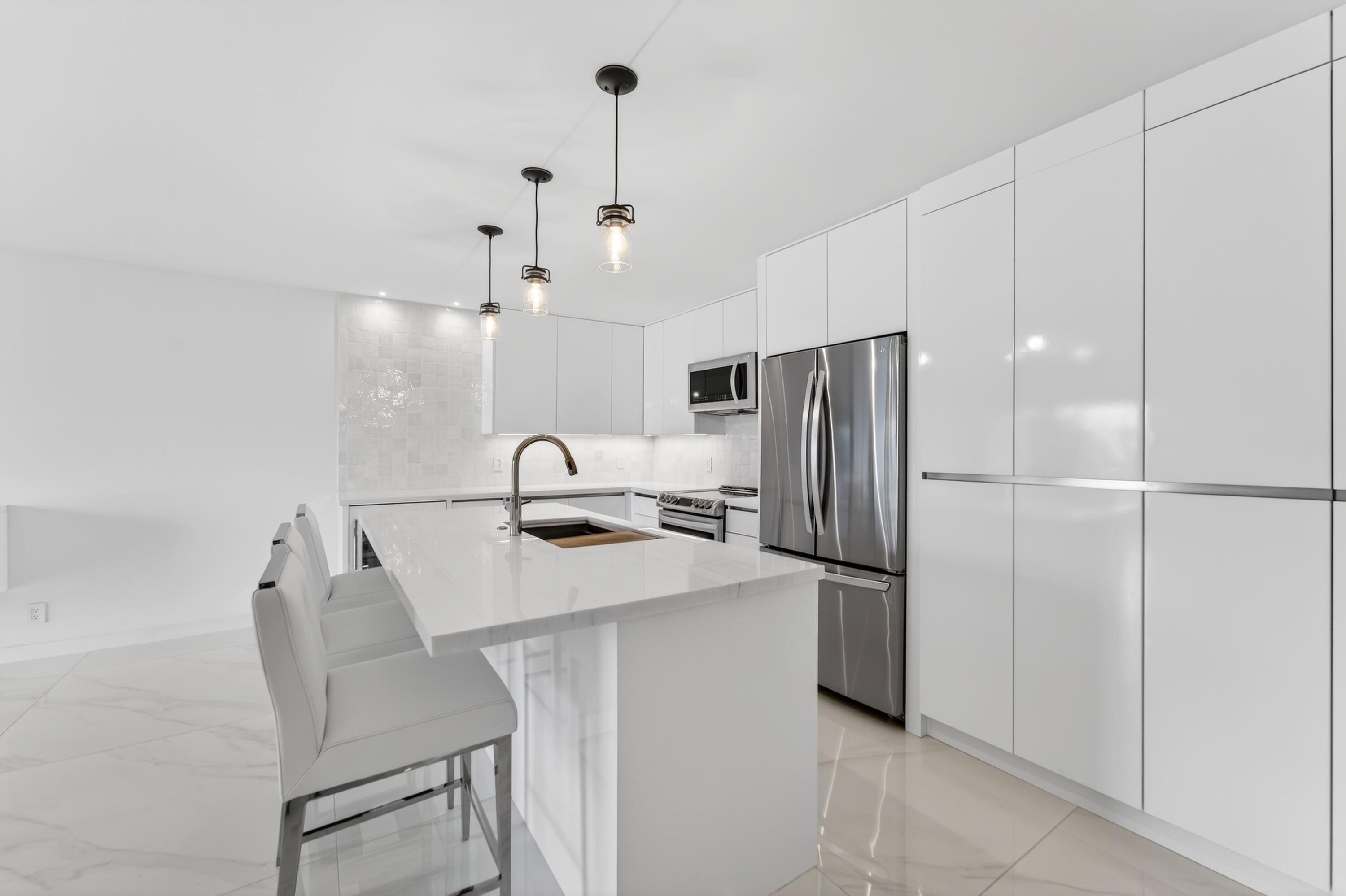 725 Hummingbird Way, Unit 103 North Palm Beach, FL 33408 - Photo 30 of 52 a kitchen with stainless steel appliances a refrigerator sink and cabinets