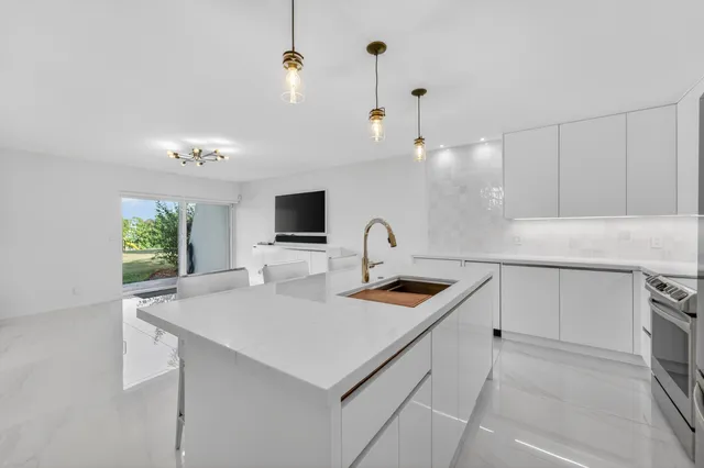 a kitchen with sink cabinets and microwave