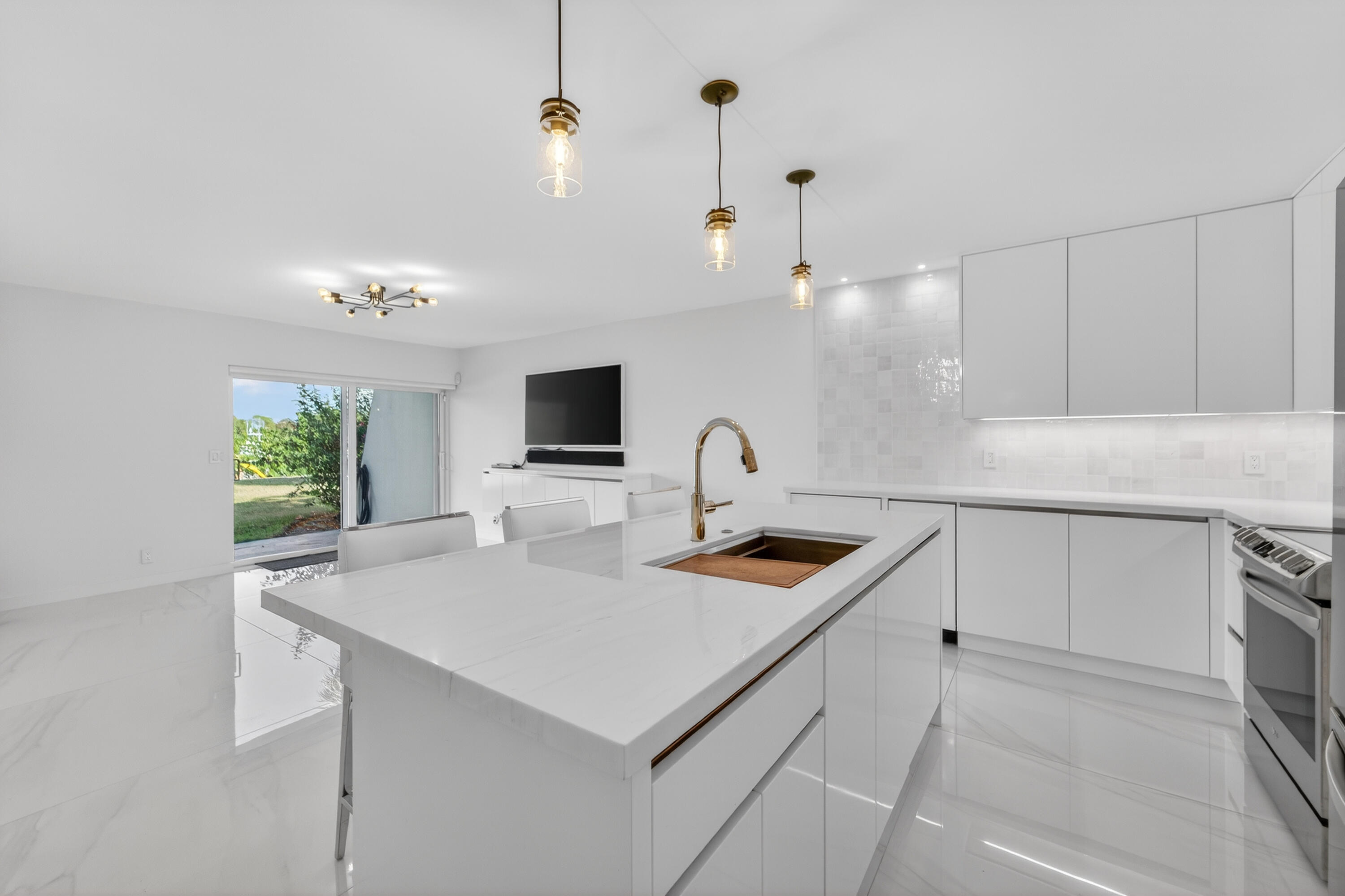 725 Hummingbird Way, Unit 103 North Palm Beach, FL 33408 - Photo 3 of 52 a kitchen with sink cabinets and microwave